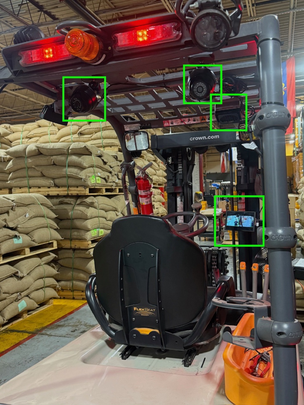 The Canary system mounted on a forklift: two cameras, the nest, and the driver display outlined